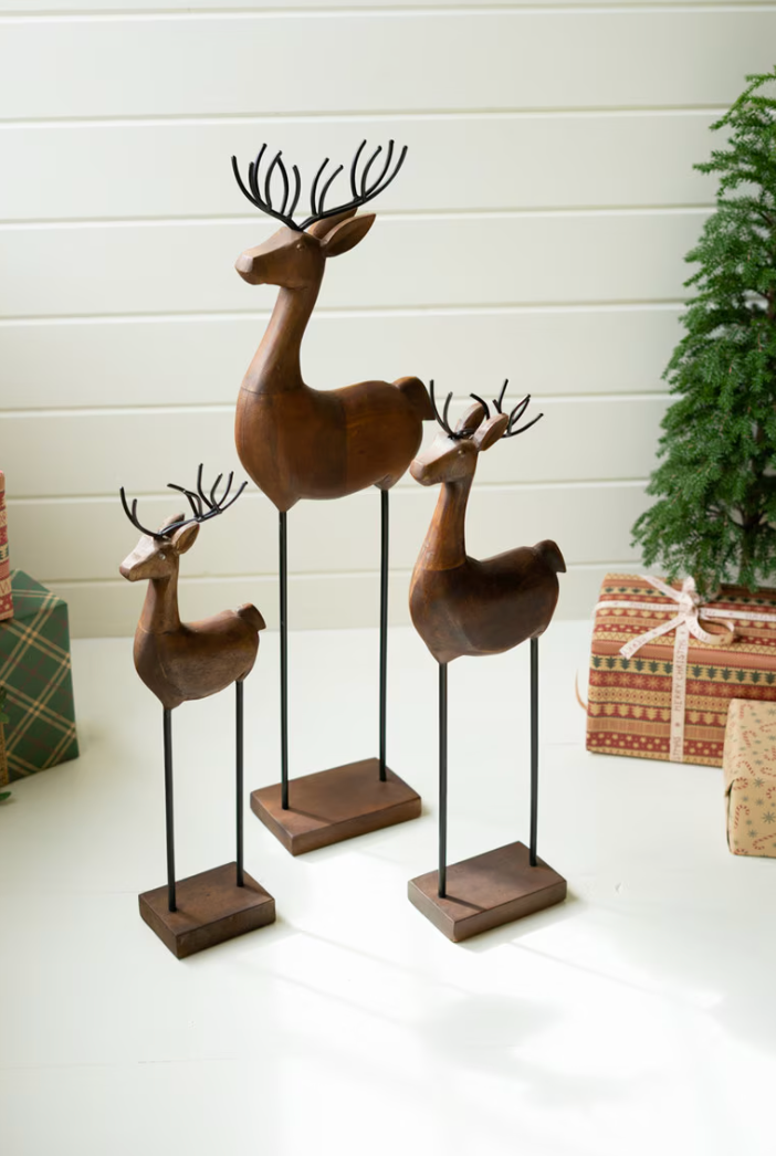 Set of three carved wood and iron reindeer