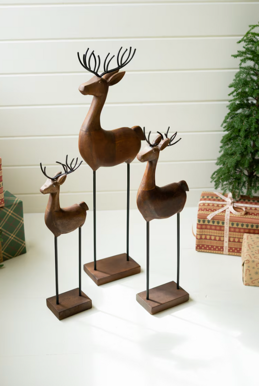 Set of three carved wood and iron reindeer
